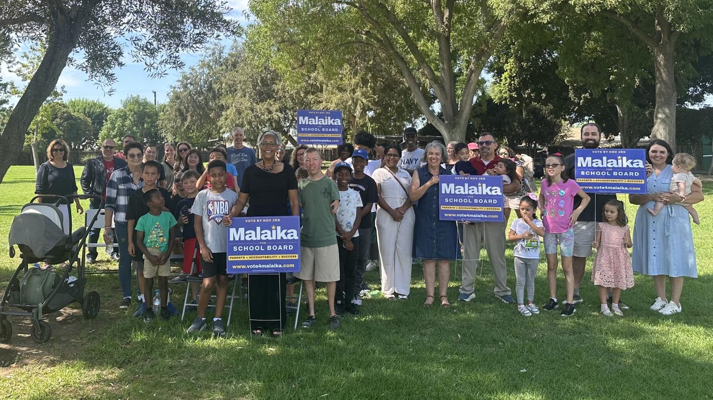 Supporters, neighbors and families gathered with Malaika Ware and campaign signs at the Neff Park kickoff, August 29, 2026.